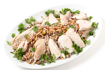 Image showing Lebanese dish of chicken and spiced rice with nuts and parsley
