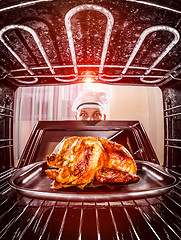 Image showing Cooking chicken in the oven.