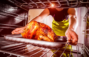 Image showing Cooking chicken in the oven at home.