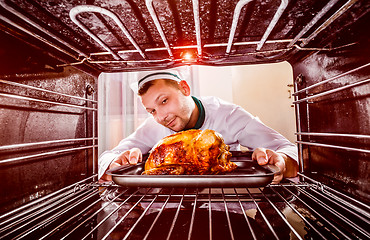 Image showing Cooking chicken in the oven.