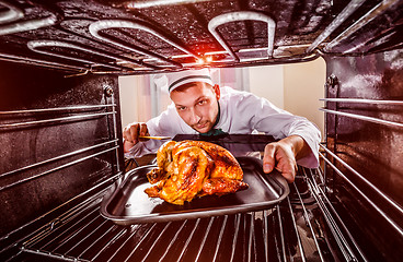 Image showing Cooking chicken in the oven.