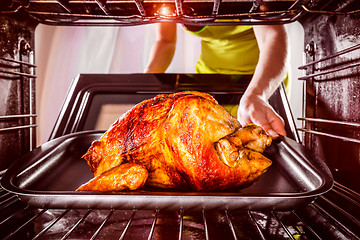 Image showing Cooking chicken in the oven at home.