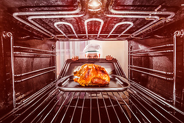 Image showing Cooking chicken in the oven.