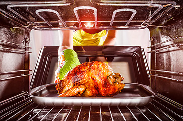 Image showing Cooking chicken in the oven at home.