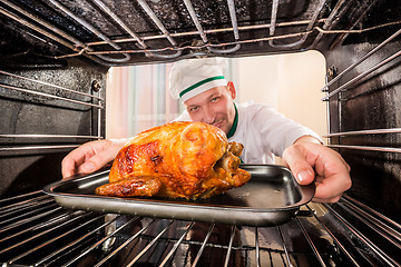 Image showing Cooking chicken in the oven.