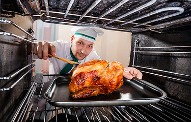 Image showing Cooking chicken in the oven.