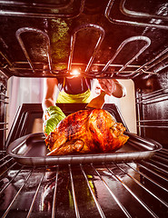 Image showing Cooking chicken in the oven at home.