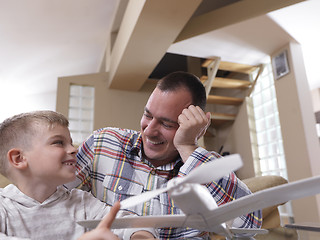 Image showing father and son assembling airplane toy