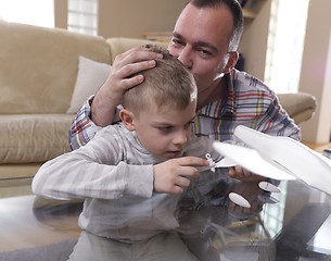 Image showing father and son assembling airplane toy