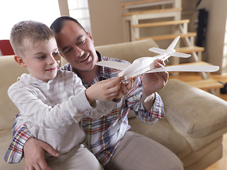 Image showing father and son assembling airplane toy