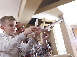 Image showing father and son assembling airplane toy