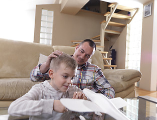 Image showing father and son assembling airplane toy