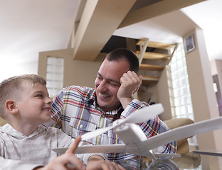 Image showing father and son assembling airplane toy