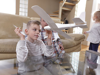 Image showing father and son assembling airplane toy