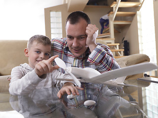 Image showing father and son assembling airplane toy