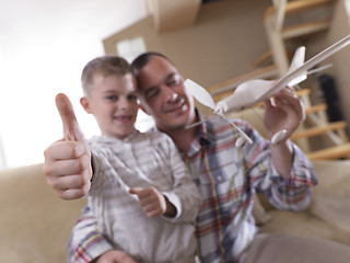 Image showing father and son assembling airplane toy