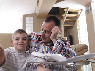 Image showing father and son assembling airplane toy