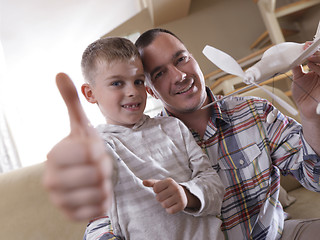 Image showing father and son assembling airplane toy