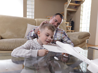 Image showing father and son assembling airplane toy