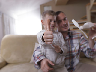 Image showing father and son assembling airplane toy