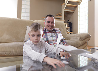 Image showing father and son assembling airplane toy