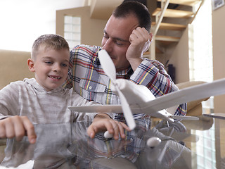 Image showing father and son assembling airplane toy