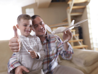 Image showing father and son assembling airplane toy