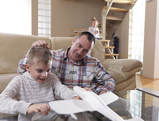 Image showing father and son assembling airplane toy