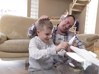 Image showing father and son assembling airplane toy