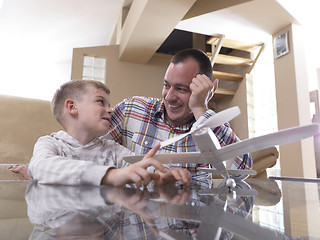 Image showing father and son assembling airplane toy