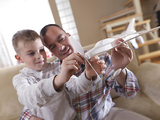 Image showing father and son assembling airplane toy