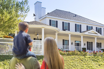 Image showing Mixed Race Young Family Looking At Beautiful Home