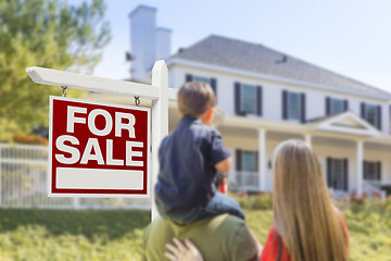 Image showing Family Facing For Sale Real Estate Sign and House