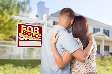 Image showing Sold For Sale Sign with Military Couple Looking at House