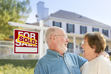 Image showing Senior Couple in Front of Sold Real Estate Sign, House