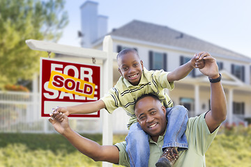 Image showing African American Father and Son, Sold Sign and Home