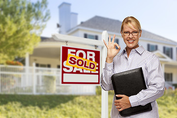 Image showing Real Estate Agent in Front of Sold Sign and House