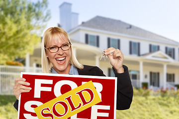 Image showing Excited Woman Holding House Keys and Sold Real Estate Sign