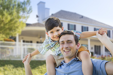 Image showing Mixed Race Father and Son Piggyback in Front of House