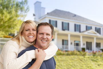 Image showing Happy Couple Hugging in Front of House