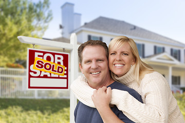 Image showing Couple in Front of New House and Sold Sign