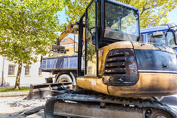 Image showing Excavator loading dumper truck.