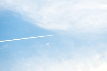 Image showing Airplane moving across blue sky