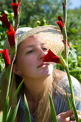 Image showing Girl with gladioluses.