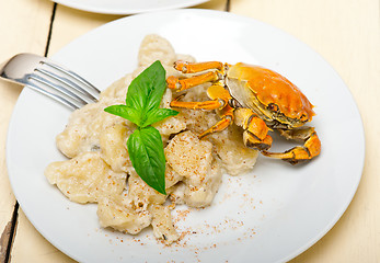 Image showing Italian gnocchi with seafood sauce with crab and basil