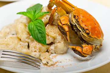 Image showing Italian gnocchi with seafood sauce with crab and basil