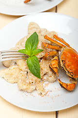 Image showing Italian gnocchi with seafood sauce with crab and basil