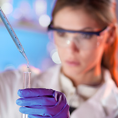 Image showing Young scientist pipetting.