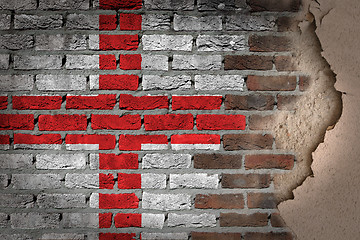 Image showing Dark brick wall with plaster - England