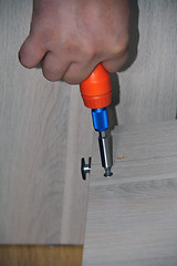 Image showing Closeup of a hand with a screwdriver